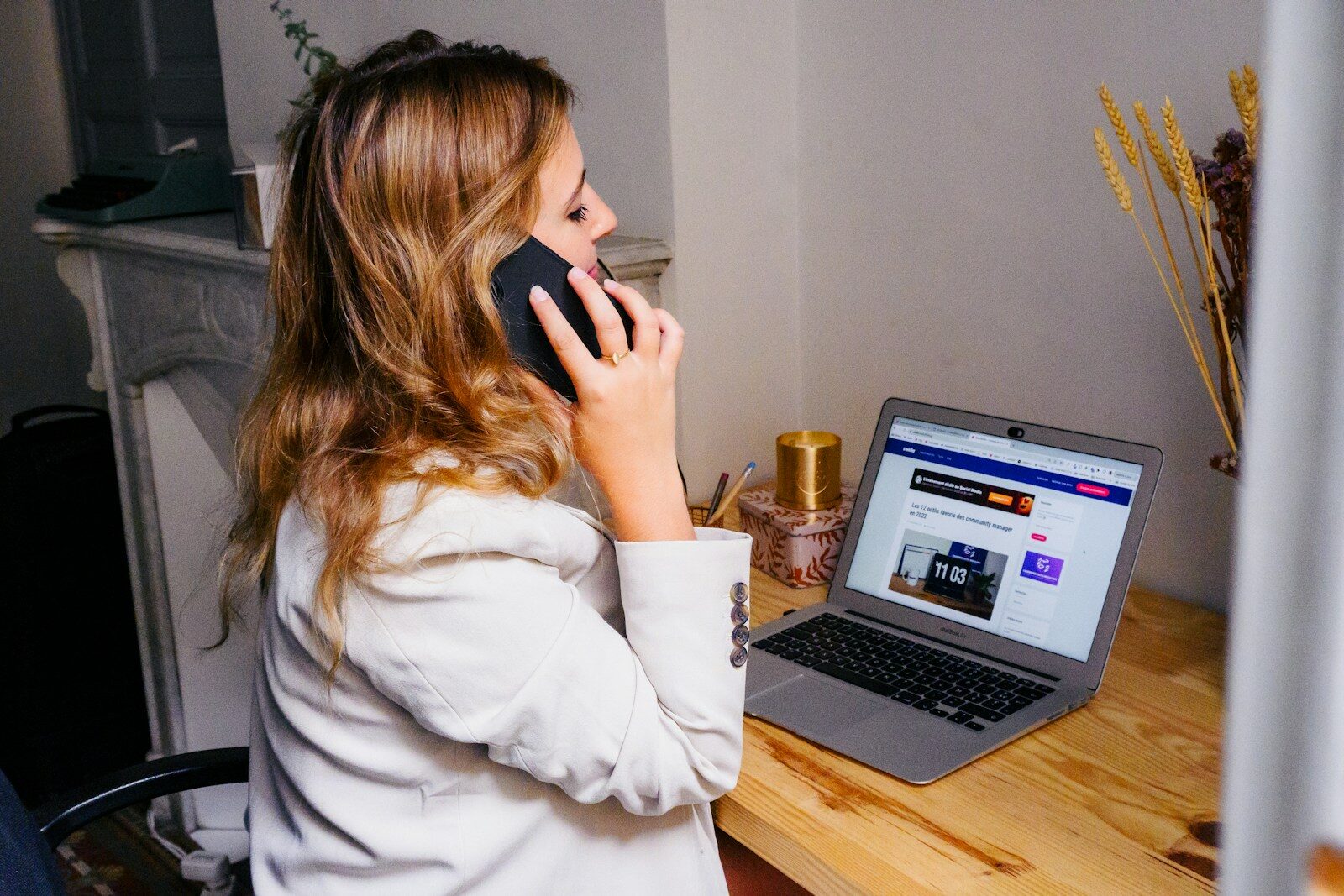 Business owner taking a phone call from a lead at her desk