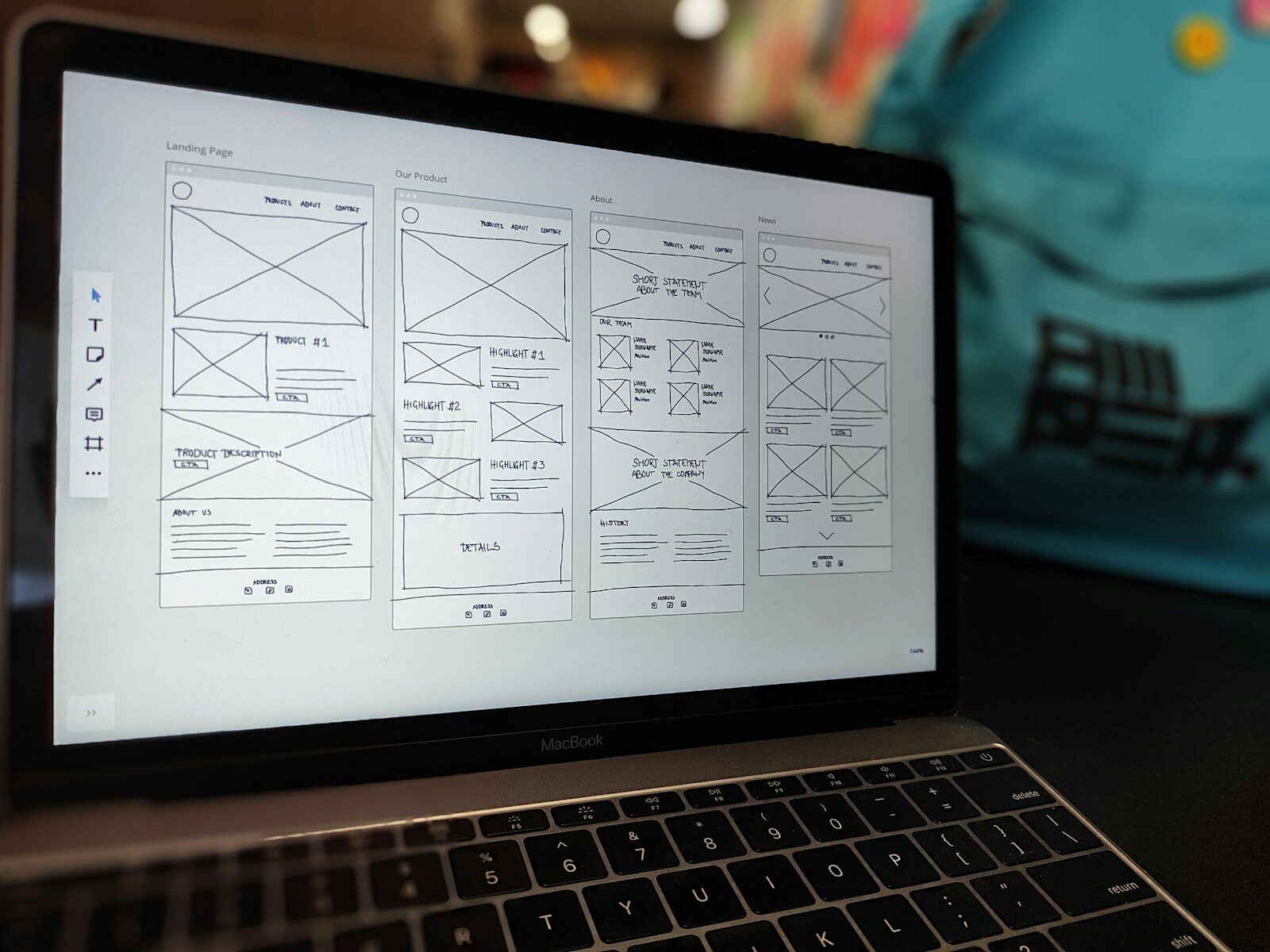 Landing page wireframe designs on a laptop screen