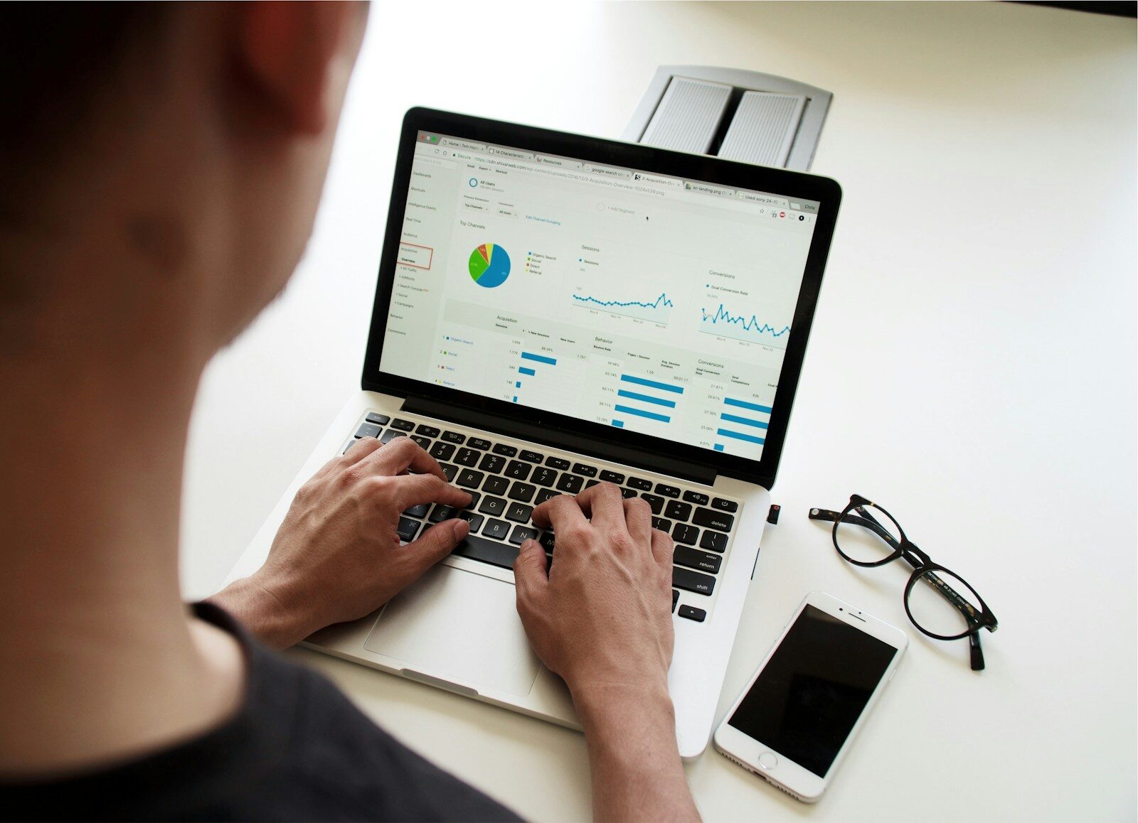 Marketer reviewing lead generation analytics dashboard on a laptop