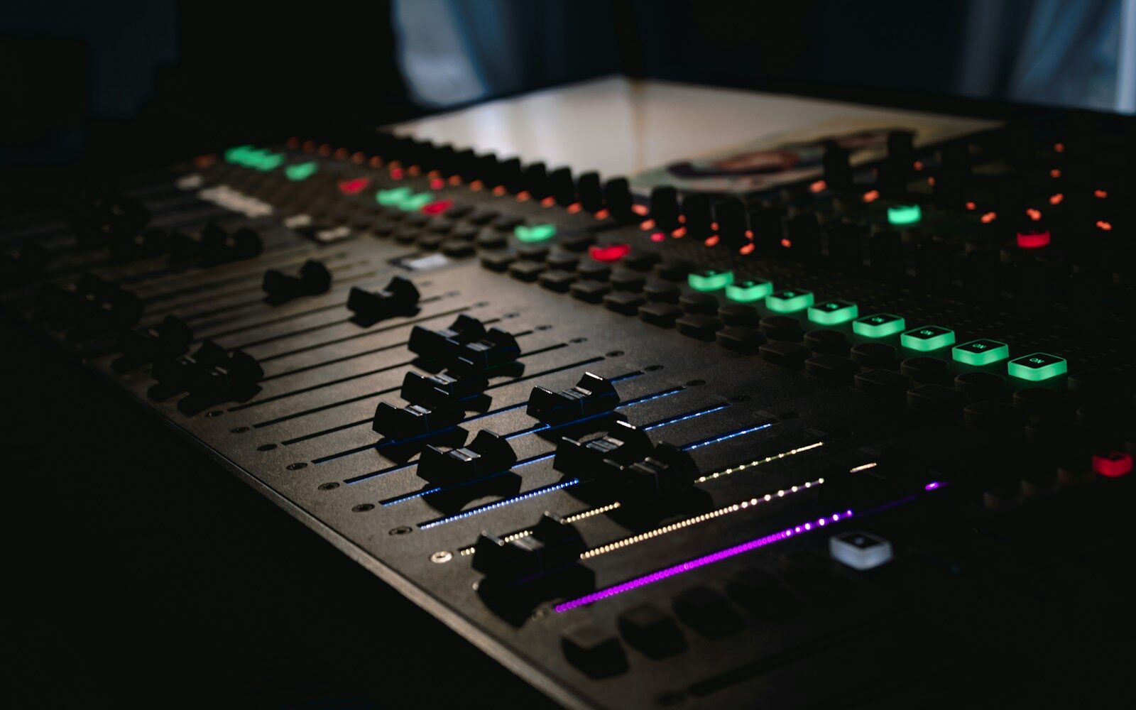 A row of mixing desk faders, the choice of which advantage+ creative enhancements to leave on or switch off
