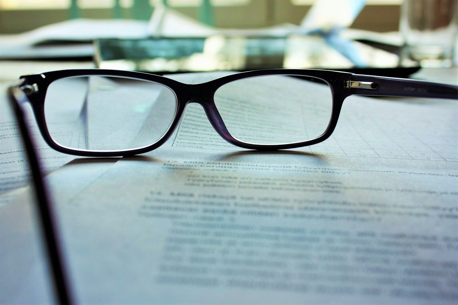 Reading glasses resting on printed policy text, the checking step before you decide whether to disclose AI generated ads